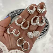 mano con varios juegos de aros plateados